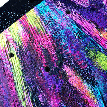close up of cosmic colors on hand painted skateboard wall art