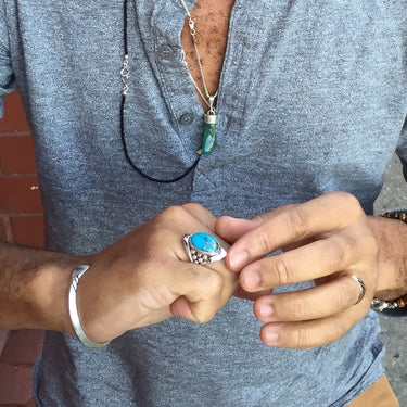 model wearing handmade turquoise and sterling silver shield mens ring