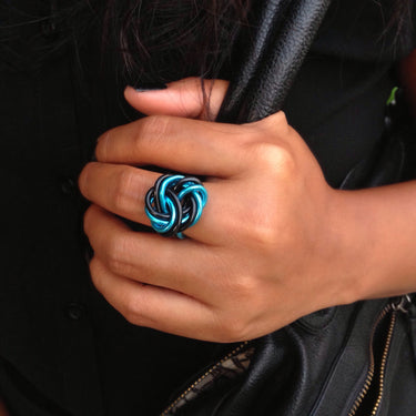 Black and turquoise color anodized aluminum wire wrap ring. 
