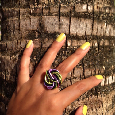 Pink, black, and light green color anodized aluminum wire wrap ring. 
