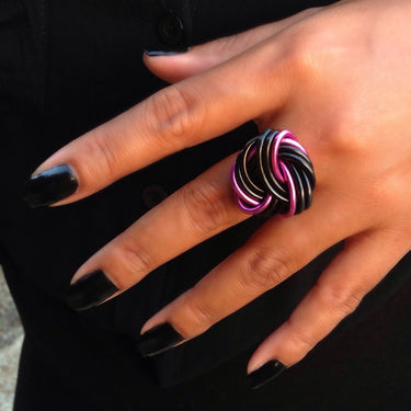 Black and hot pink color anodized aluminum wire wrap ring.
