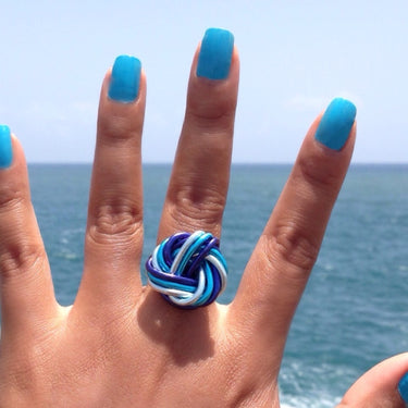 Light blue, turquoise, and dark blue color anodized aluminum wire wrap ring. 
