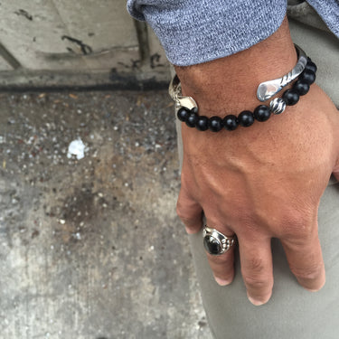 model wearing sterling silver and pyrite gemstone paired with black onyx bracelet 