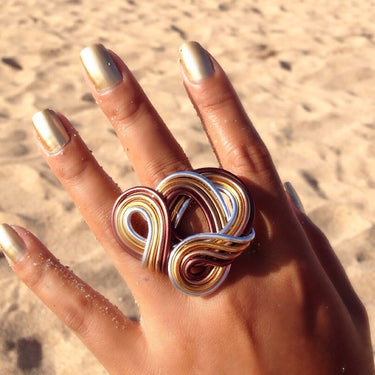 Brown, silver, and gold color anodized aluminum wire wrap ring.