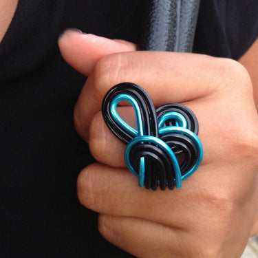 Black and blue color anodized aluminum wire wrap ring. 
