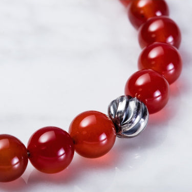 Carnelian 8mm beads bracelet with sterling silver lobster clasp. Has one accent sterling silver wave bead.