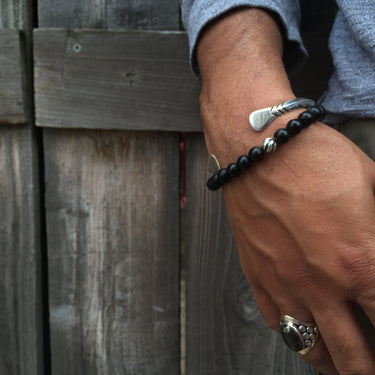 front view of hand on model wearing black onyx bead bracelet