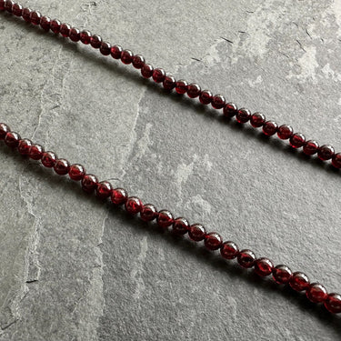 close up of red garnet beads necklace for men