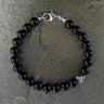 Gloss black onyx 8mm beads with one accent sterling silver wave bead bracelet 