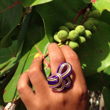 Light green, purple, and pink color anodized aluminum wire wrap ring.