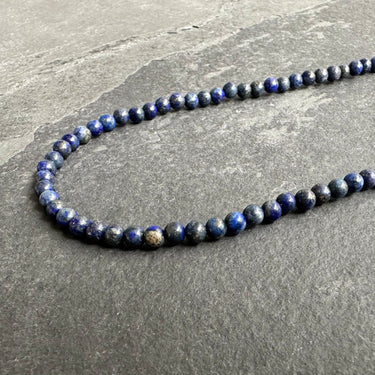 side view closeup of necklace of lapis lazuli for men