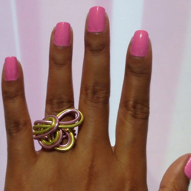 Pink and light green anodized aluminum wire wrap ring.