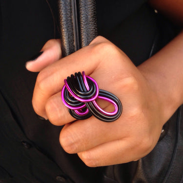 Pink and black color anodized aluminum wire wrap ring. 
