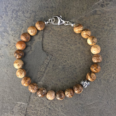 Picture jasper 8mm bead bracelet with one accent sterling silver wave bead. With Sterling silver components and a lobster clasp.