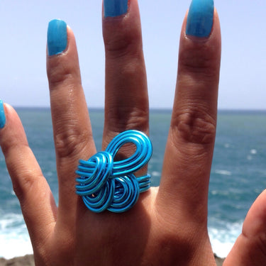 Turquoise anodized aluminum wire wrap ring.
