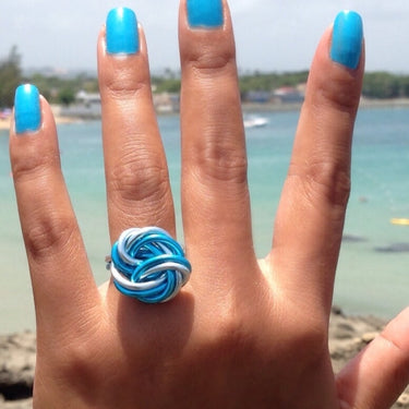 Light blue and turquoise color anodized aluminum wire wrap ring.
