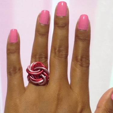 Pink and red color anodized aluminum wire wrap ring.

