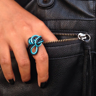 Black and blue color anodized aluminum wire wrap ring. 
