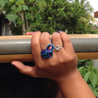 Purple and turquoise color anodized aluminum wire wrap ring. 
