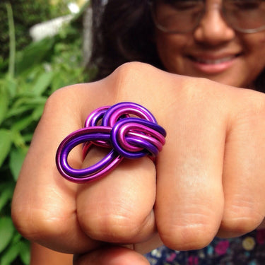 Purple and fuchsia color anodized aluminum wire wrap ring. 
