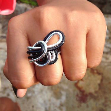 Silver and black anodized aluminum wire wrap ring.

