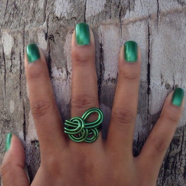 Dark green anodized aluminum wire wrap ring.

