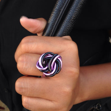 Black and pink color anodized aluminum wire wrap ring. 

